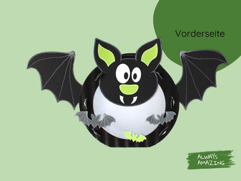 Vorderseite Fledermaus-Laterne mit schwarzen Flügeln, großen Augen und grünen Details