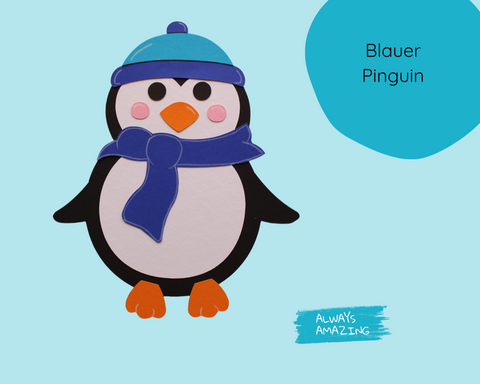 Blauer Pinguin mit blauer Wintermütze und passendem Schal aus vorgestanztem Tonkarton, als winterliches Fensterbild zum Basteln.